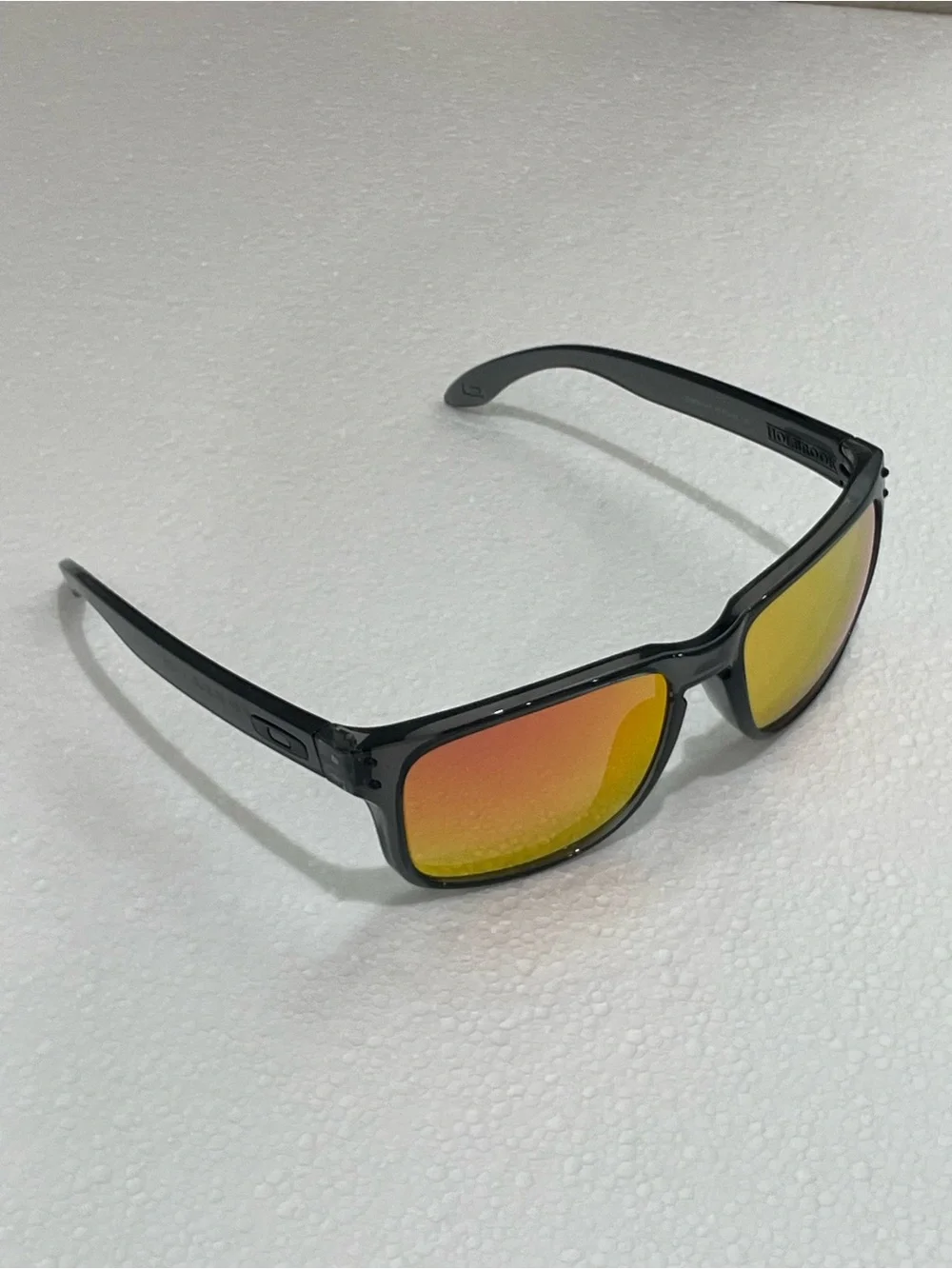 Oakley Translucent Black Frame Sunglasses with Yellow Mirrored Lenses